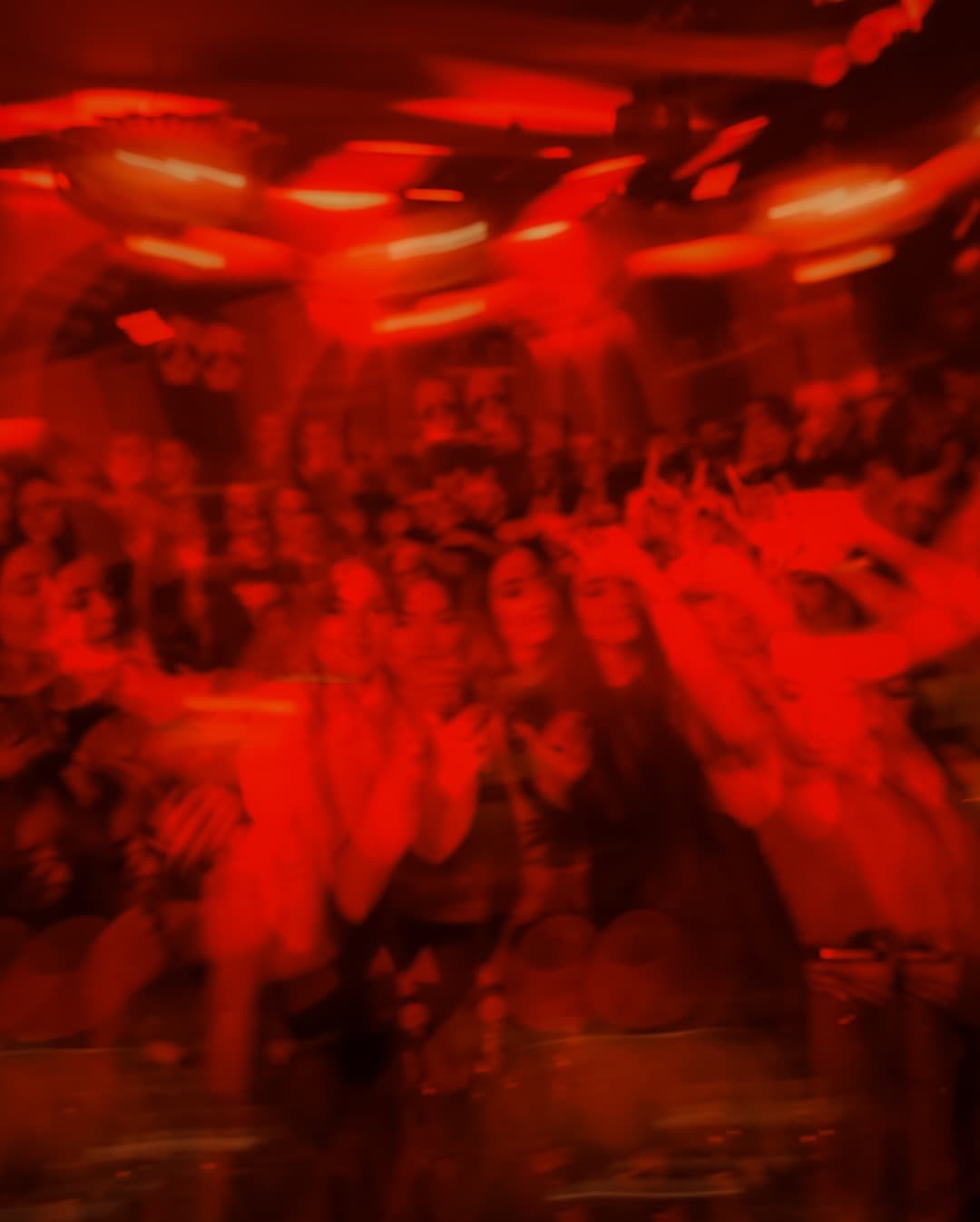 Motion blur crowd in red light — GRAPE