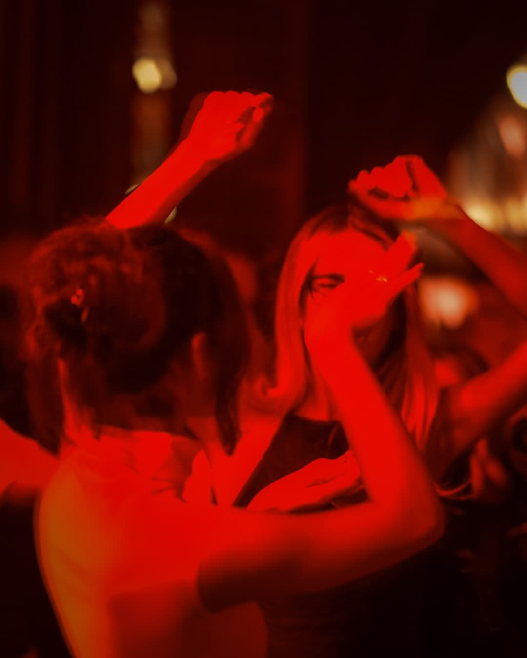 Dancers in crimson light at GRAPE