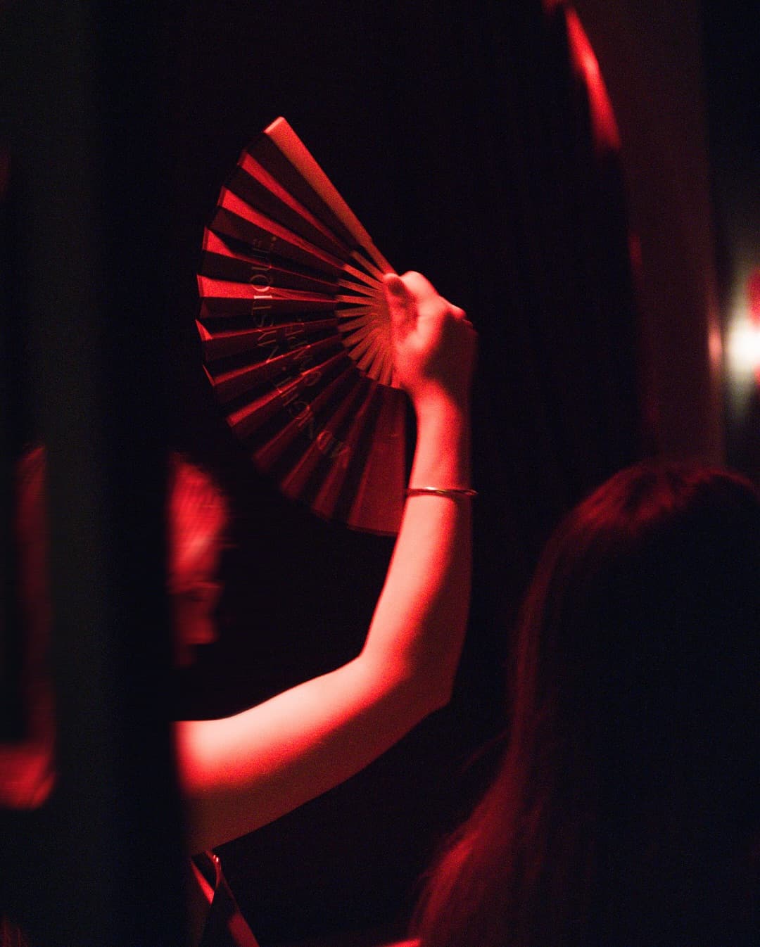 Elegance at GRAPE — a guest in red candlelight